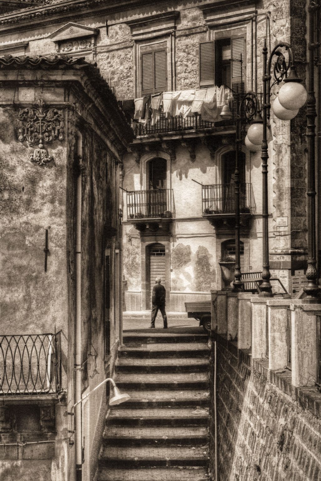 Santa Fe Marketplace Man Atop Staircase, Sicily, 2005 Product Image: Man Atop Staircase, Sicily, 2005